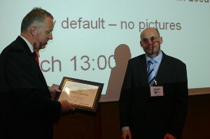 Adm. Voogt (l) presents a certificate of appreciation to Frank Zeppenveldt, system engineer, satellite communications department, ESTEC, for his presentation on security and communications initiatives in March.